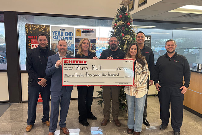 Group of people holding giant check