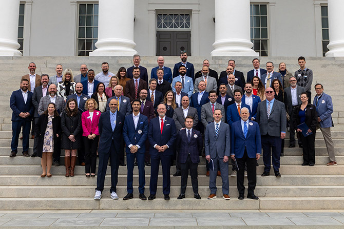 Group of dealers in businesswear standing on Capitol steps